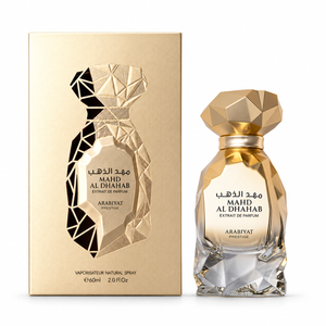 Arabiyat Prestige Mahd Al Dhahab Extrait de Parfum 60ml gold perfume bottle beside its matching gold box on a white background.